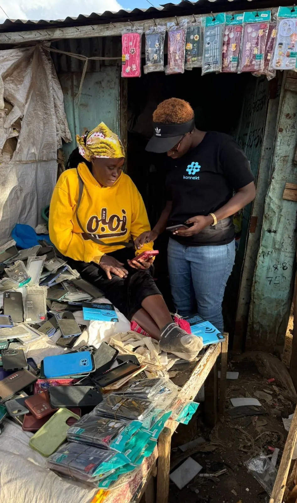 A konnekt agent connects a phone-accessories trader to BlueZone Wi-Fi at her market stall