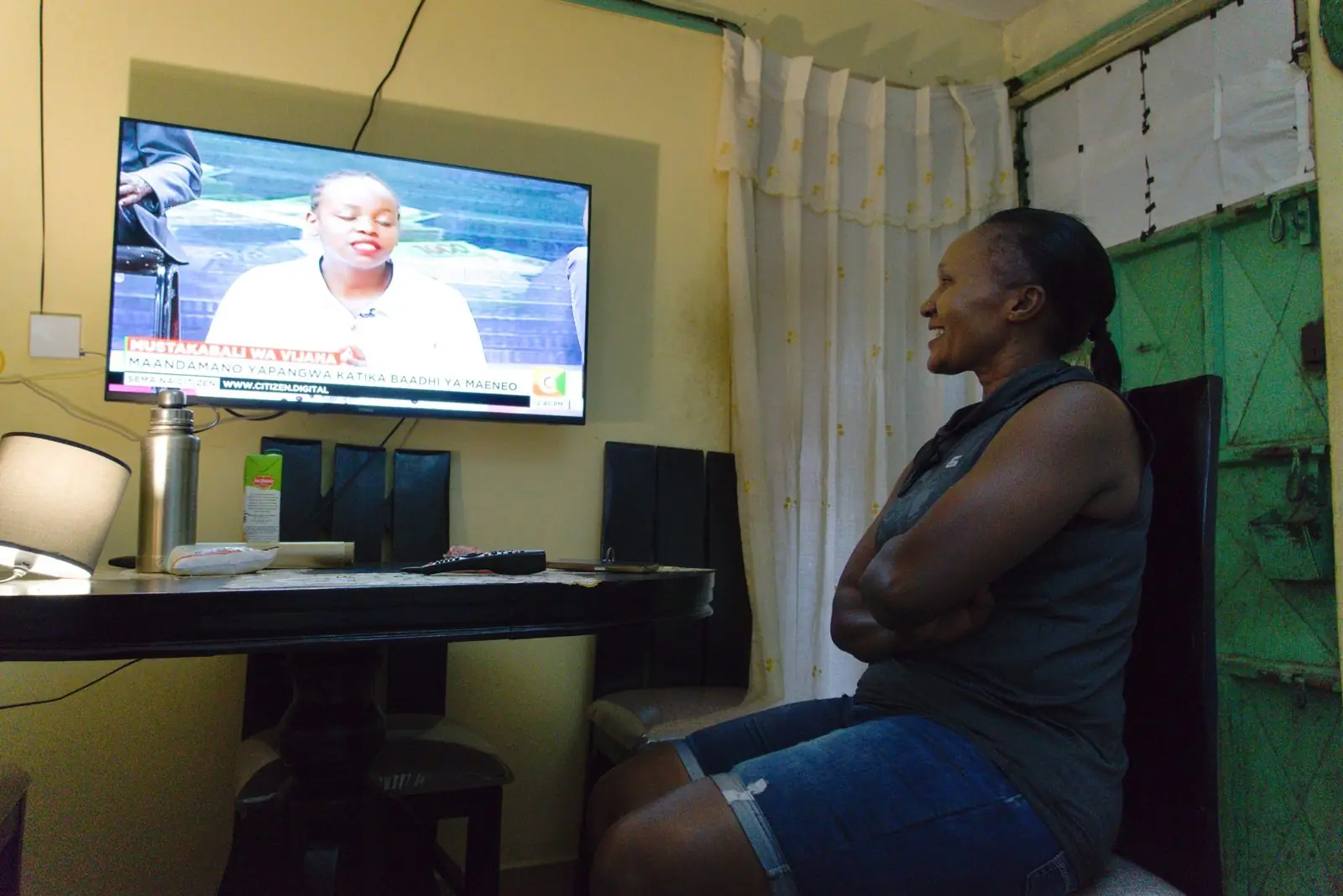 A woman watching TV at home
