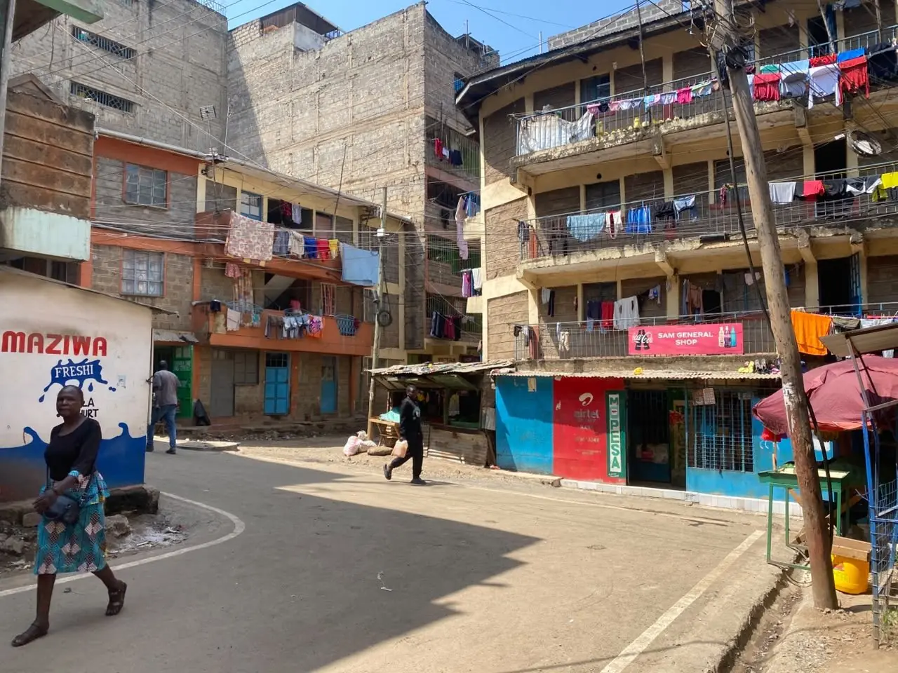 A Nairobi street lined with multi-storey apartment blocks and shops