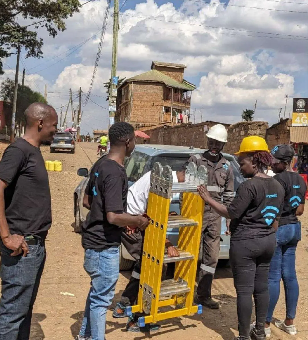 The konnekt team with a ladder preparing a building connection on an apartment street