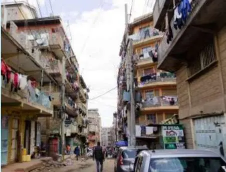 A narrow Nairobi street between tall apartment blocks